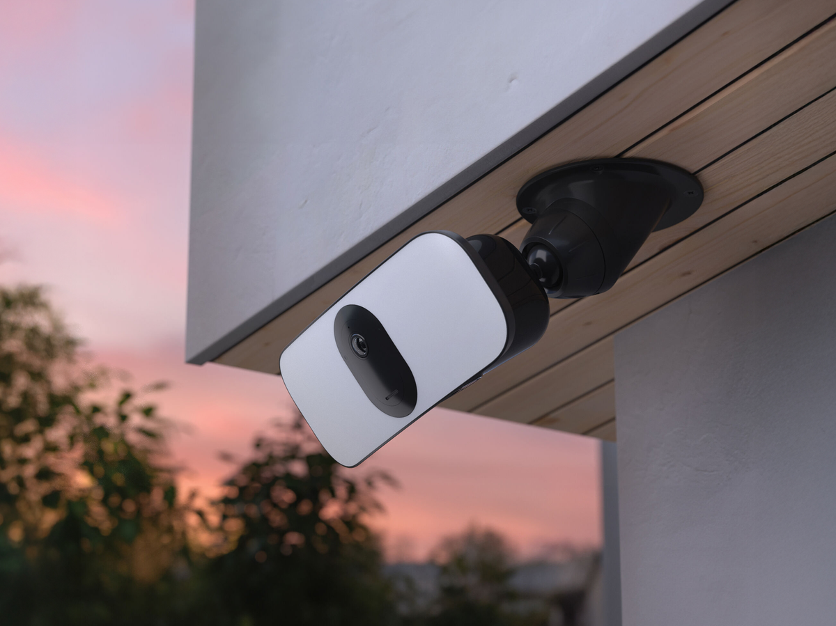 A floodlight camera mounted on a ceiling adapter