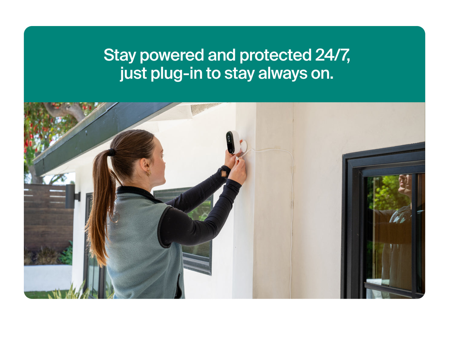 Person installing a Arlo Essential Plug-In Security Camera on a wall with promotional text about power and protection.