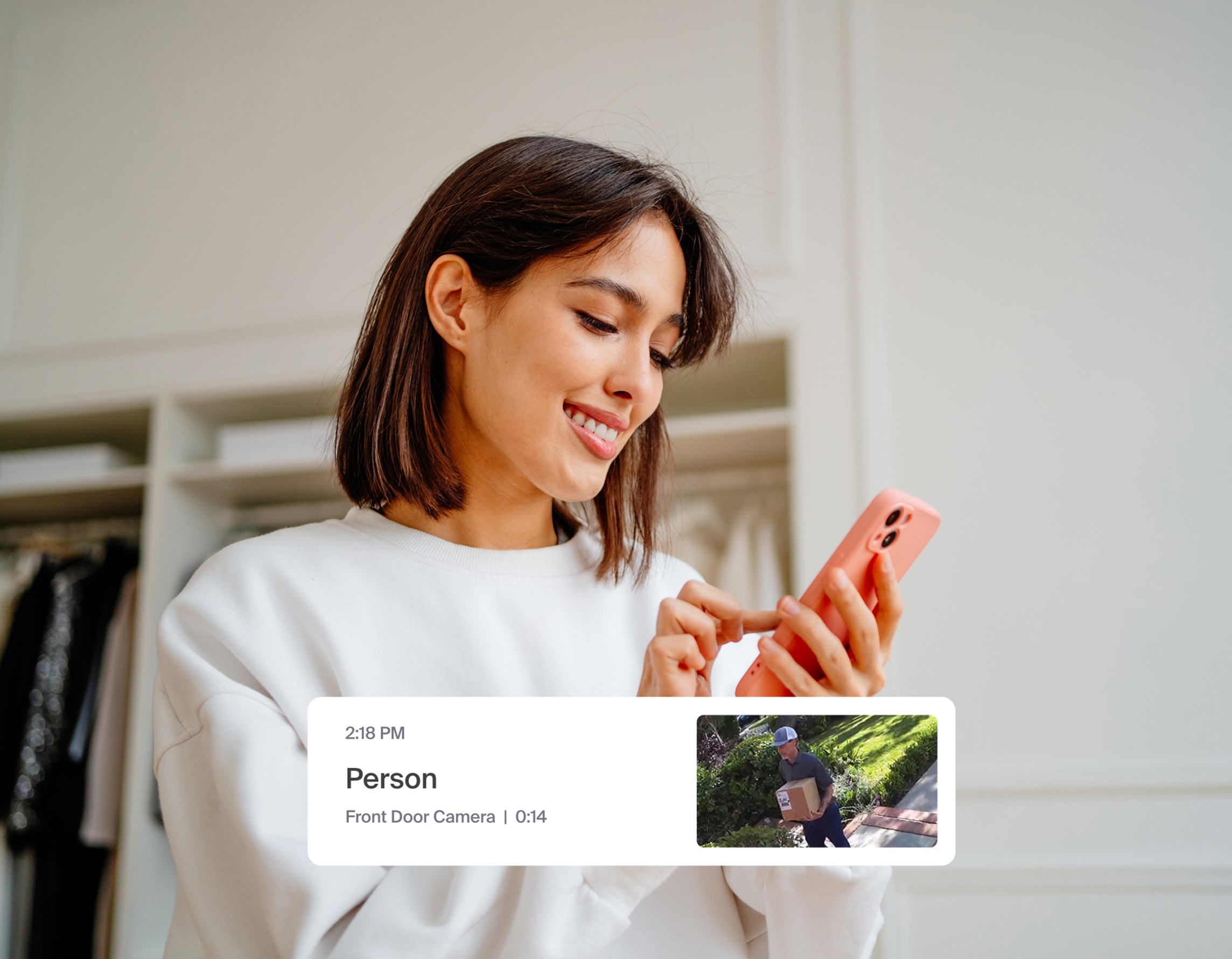 A woman looking at her phone with the Arlo Secure app pop-up notification