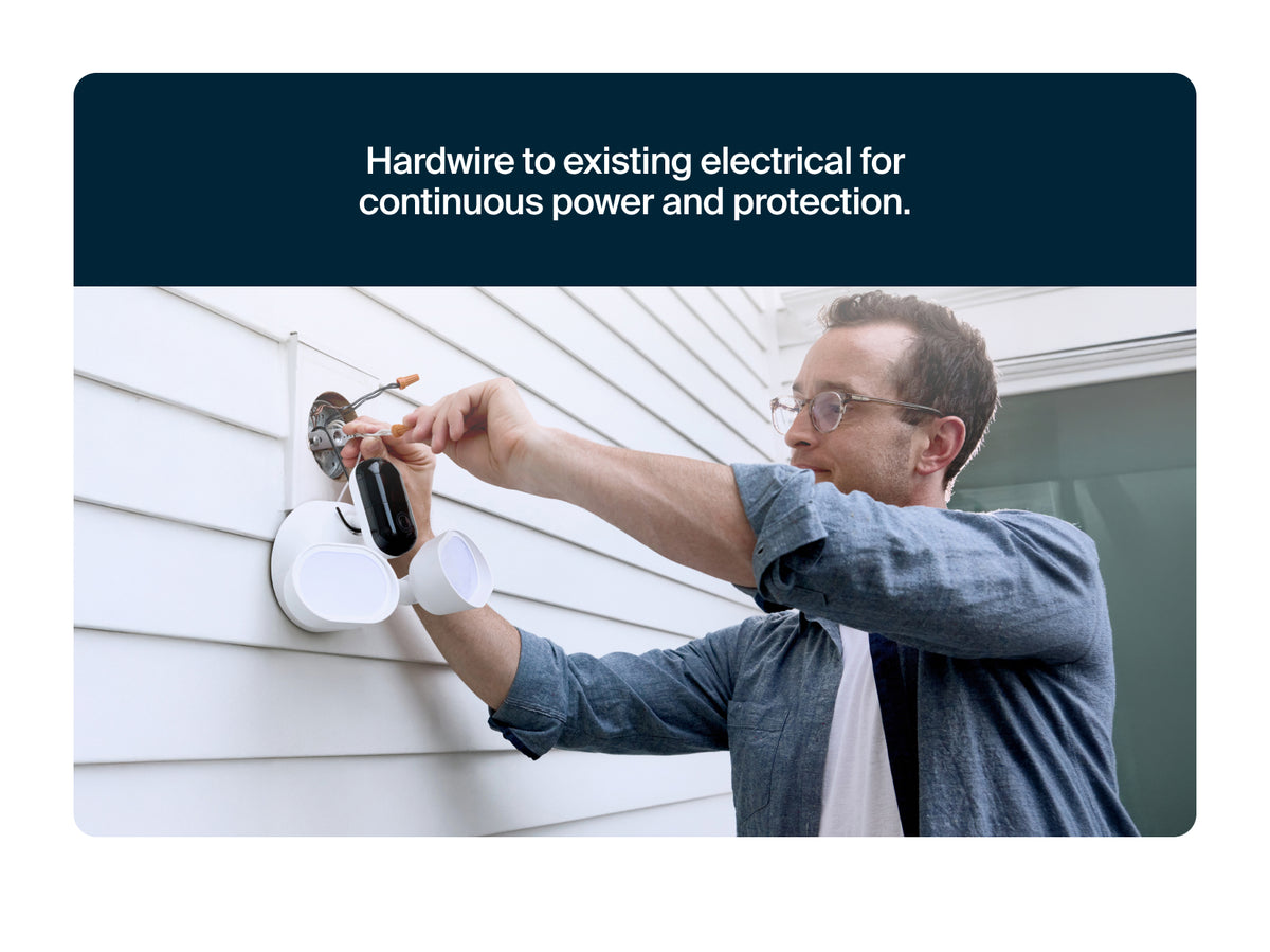Person installing Arlo Wired Floodlight on a wall with text about continuous power and protection.